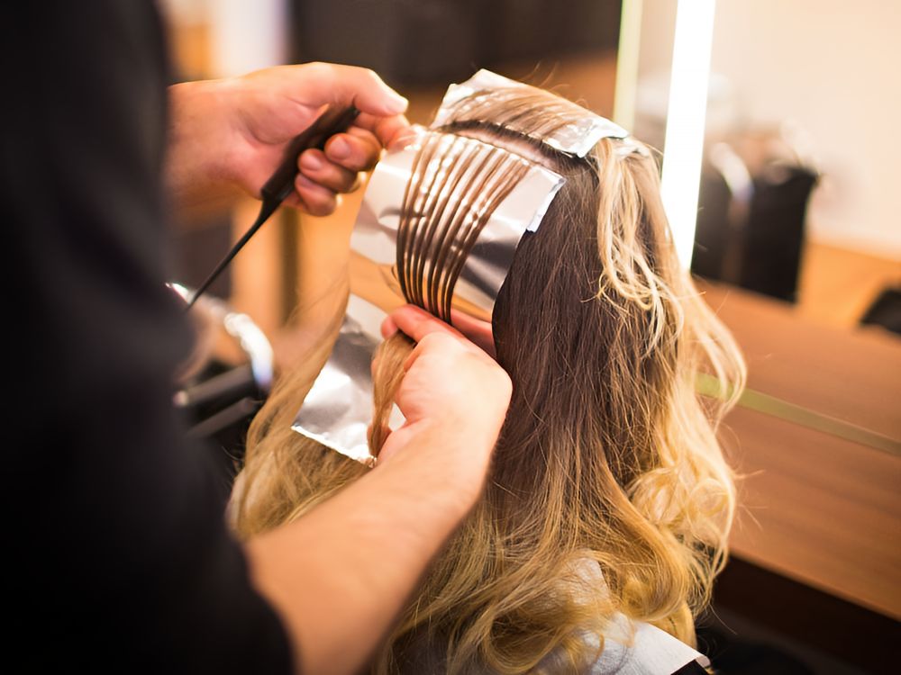 woman getting foil highlights at a hair salon