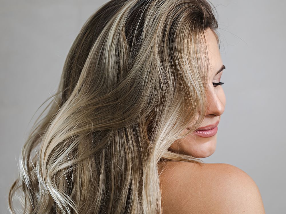 beautiful young woman with long hair that showcases the babylights hair color trend